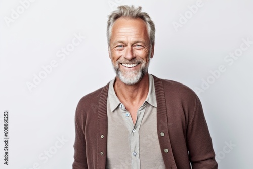 Portrait of a happy senior man smiling at the camera over white background