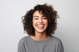 Portrait of a beautiful young african american woman laughing against white background