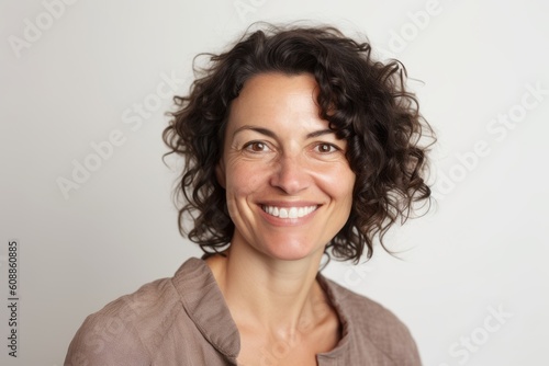 Portrait of a smiling woman with curly hair on a white background