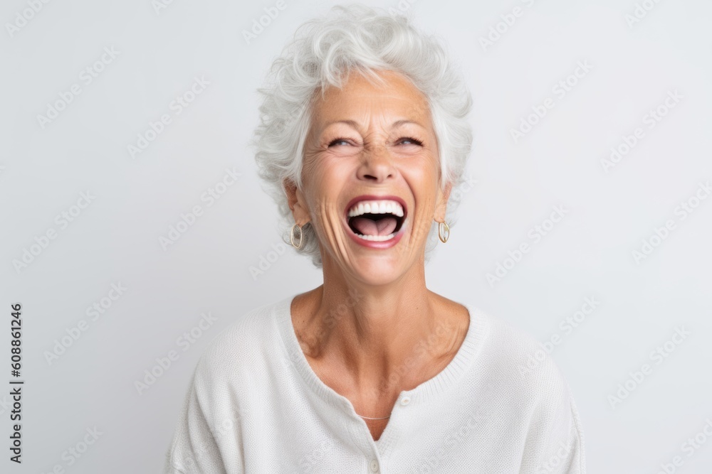 Close up portrait of a happy senior woman laughing isolated on a white background Close up portrait of a happy senior woman laughing isolated on a white background
