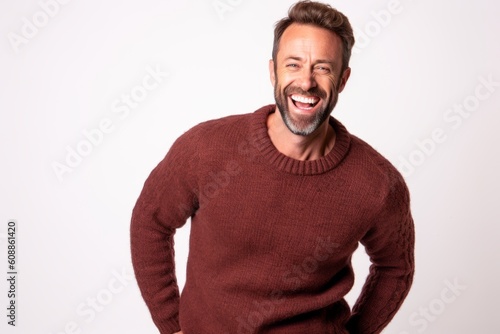 Portrait of a happy mature man laughing and looking at camera isolated on a white background