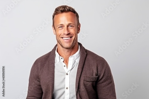 Portrait of a handsome man smiling and looking at camera isolated on a white background