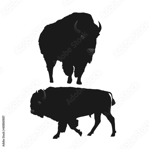 A black and white image of sihlouette two bison