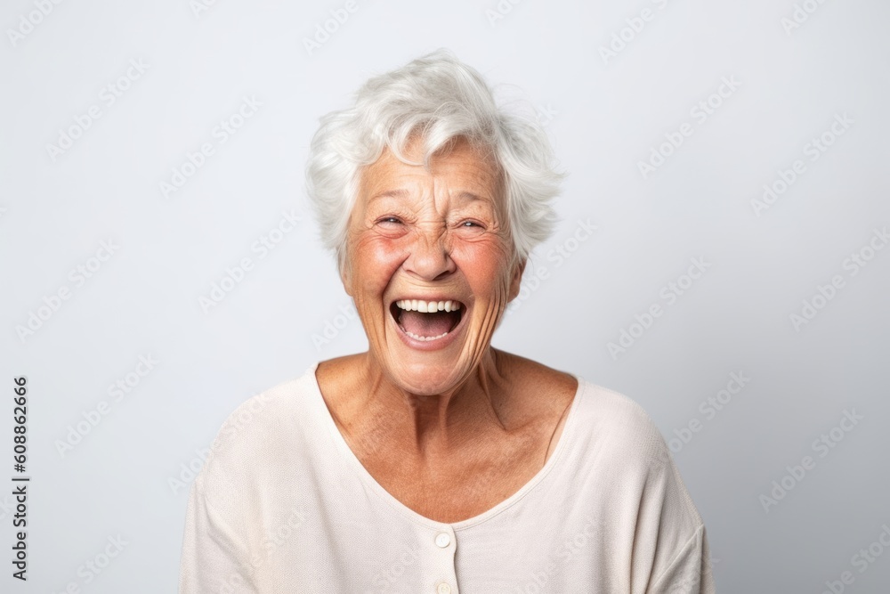 Portrait of a happy senior woman laughing isolated on a white background