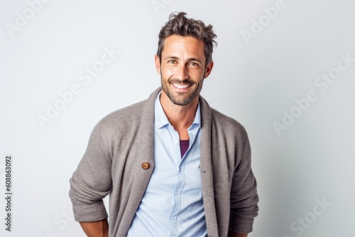 Portrait of a handsome man smiling at the camera over gray background