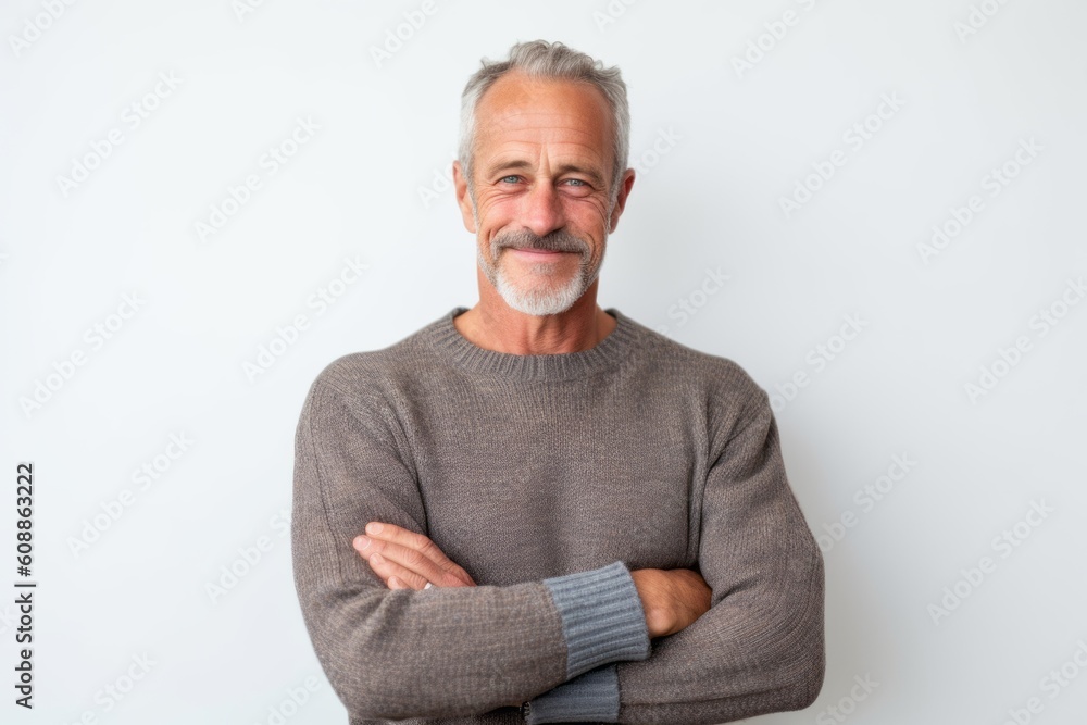 Portrait of handsome senior man with arms crossed standing against white background Portrait of handsome senior man with arms crossed standing against white background
