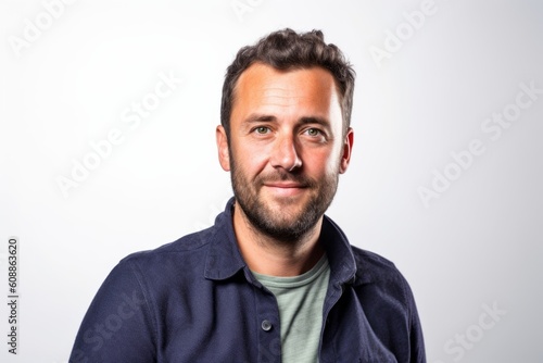 Portrait of a handsome young man smiling on a white background. © Robert MEYNER