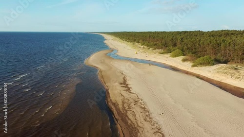 Aerial View of the Baltic Sea Coastline Garciems, Latvia. Empty Beach and Dunes in Summer Evening Before Sunset. Riga Gulf in Baltic Sea, Latvia. photo