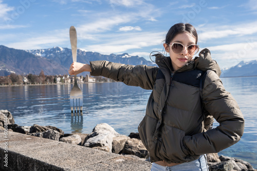 Woman tourist pose with the fork on lake Geneva, Vevey, Switzerland