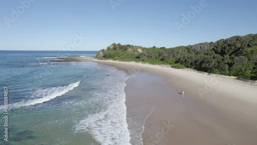 Tourists Walking On The Scenic Coast Of The Beach In Wenonah Head, Urunga, NSW, Australia - aerial drone shot photo