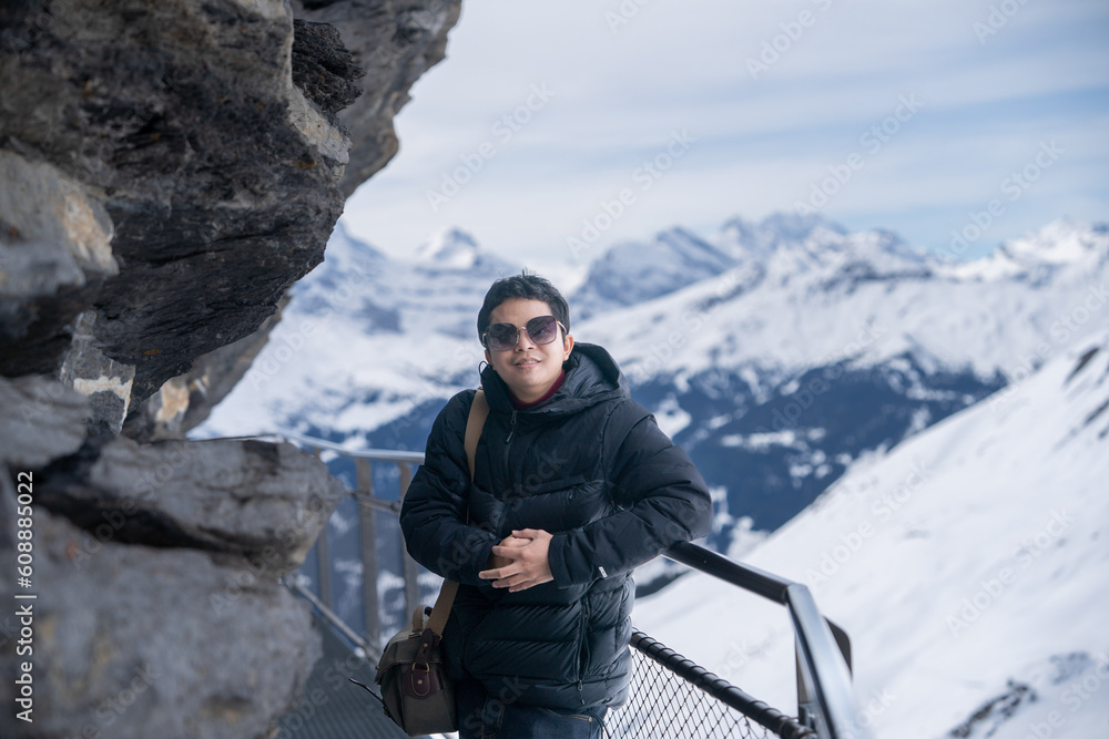 Grindelwald first, Switzerland .Man on First Cliff Walk viewing platform on the First mountain in Grindelwald with Alpine views.