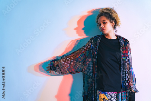 Fotografie Fashion portrait of a black woman in a fashionable outfit shot in a studio with colorful lighting