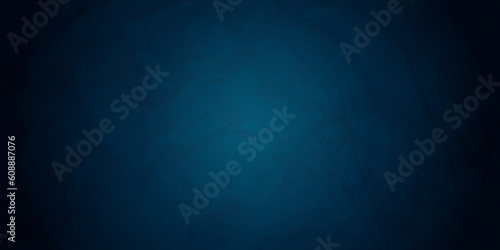 Closeup of dark blue textured grunge background. Dark edges
