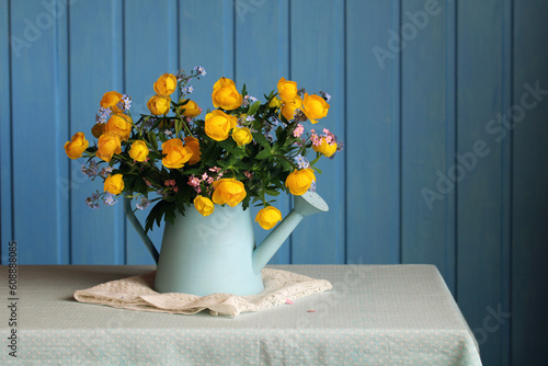 A bouquet of forget-me-nots and yellow globeflowers. photo