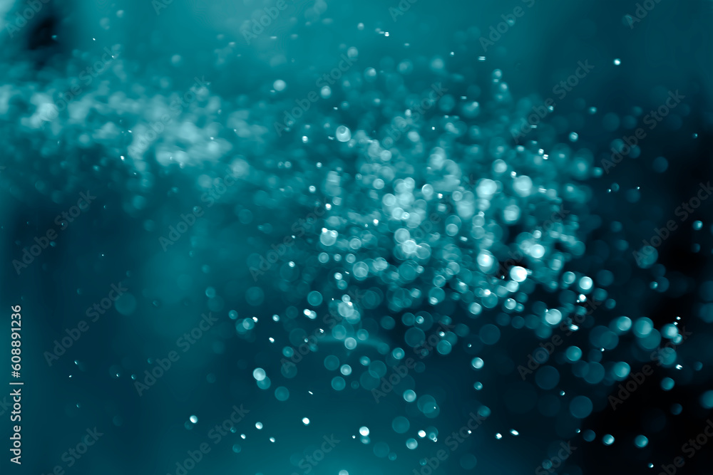 Bokeh glitter on blue-green light effects background. Bokeh glitter on blue-green light effects background.