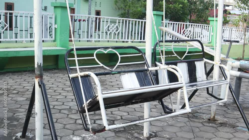 video of an empty swing in a children's playground. concept video about being alone video of an empty swing in a children's playground. concept video about being alone