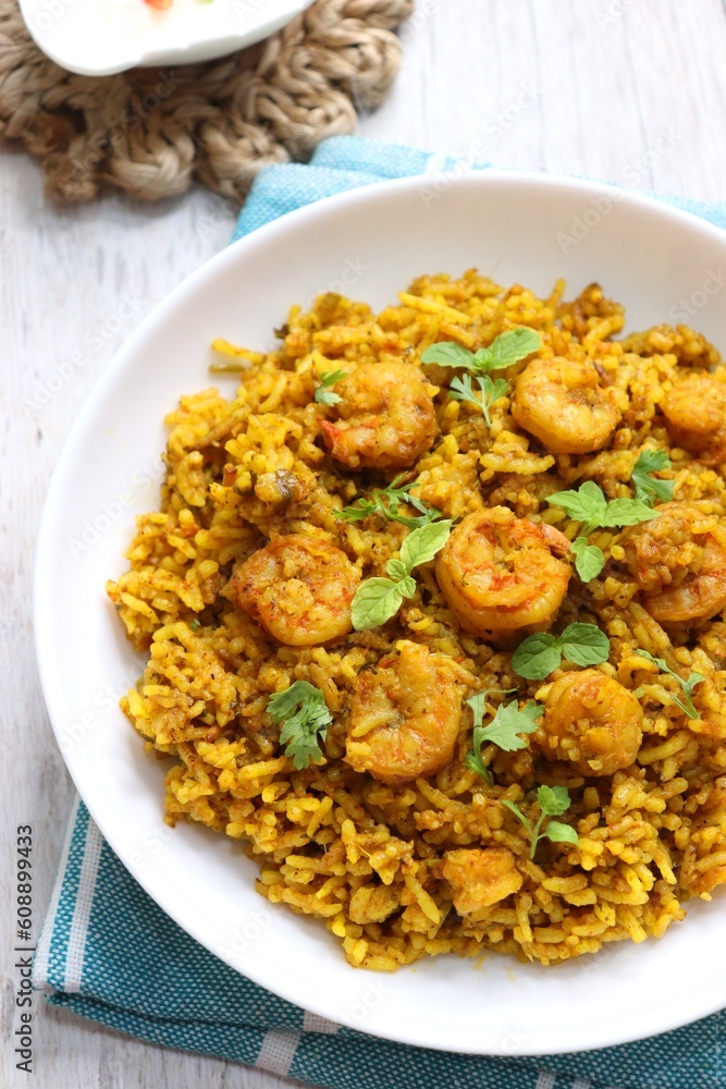 Prawns Biryani or shrimp Pulao. also called jheenga pilaf or jhinga biryani in India. known as Kolambi bhat in Marathi. Garnished with mint leaves, and coriander along with yogurt Raita. Copy space Prawns Biryani or shrimp Pulao. also called jheenga pilaf or jhinga biryani in India. known as Kolambi bhat in Marathi. Garnished with mint leaves, and coriander along with yogurt Raita. Copy space