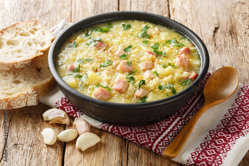 dish of Ukrainian cuisine kulish made of millet, potatoes, onions with bacon close-up in a plate on the table. horizontal photo