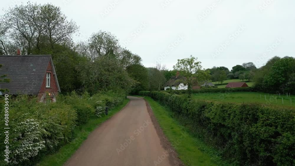 Immerse yourself in picturesque Brinkhill village, UK, via cinematic aerial video. Red rooftops, brick houses, thatched homes, and rural farmlands revealed. Immerse yourself in picturesque Brinkhill village, UK, via cinematic aerial video. Red rooftops, brick houses, thatched homes, and rural farmlands revealed.