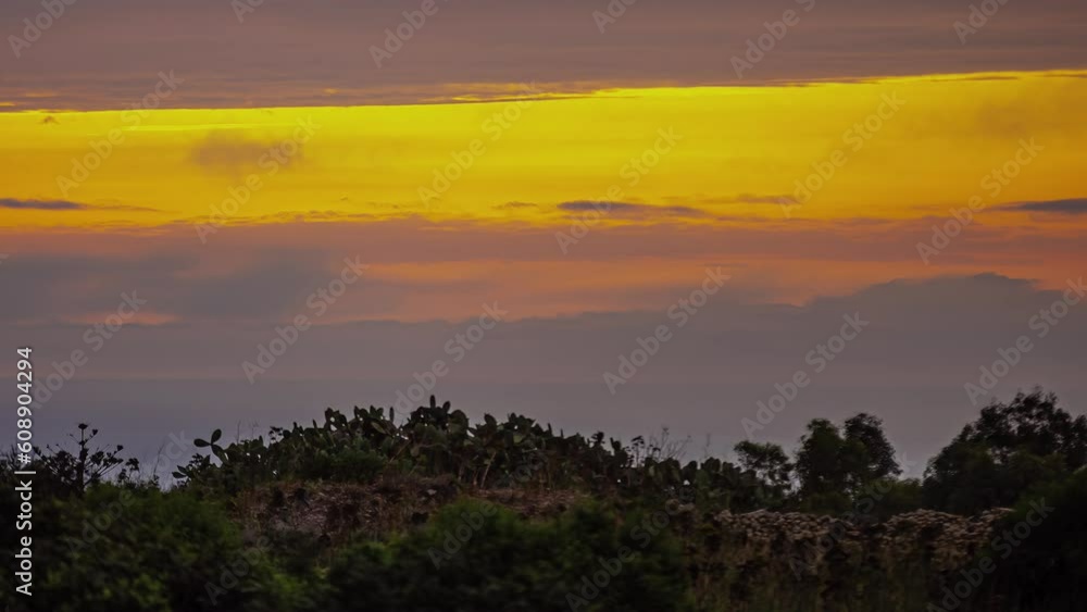 Timelapse of the gold sky with moving clouds over vegetation. Timelapse of the gold sky with moving clouds over vegetation.