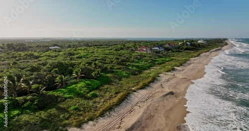 North Beach Florida Aerial v1 cinematic low level drone flyover along coastline capturing oceanfront beautiful upscale homes with waves crashing the shore - Shot with Mavic 3 Cine - March 2022 photo