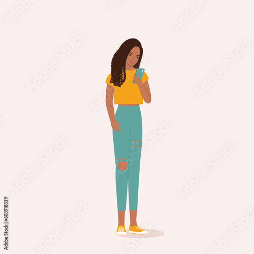 One Smiling Black Teenage Girl In Ripped Jeans Using Her Mobile Phone While Standing. Digital Native. Full Length. Flat Design Style, Character, Cartoon.