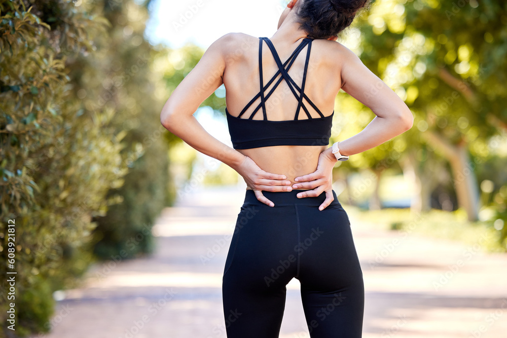 Back pain, injury and woman outdoor during exercise, training or running  accident. Fitness, spine problem and female athlete with arthritis,  fibromyalgia or emergency during body workout at park. Stock Photo