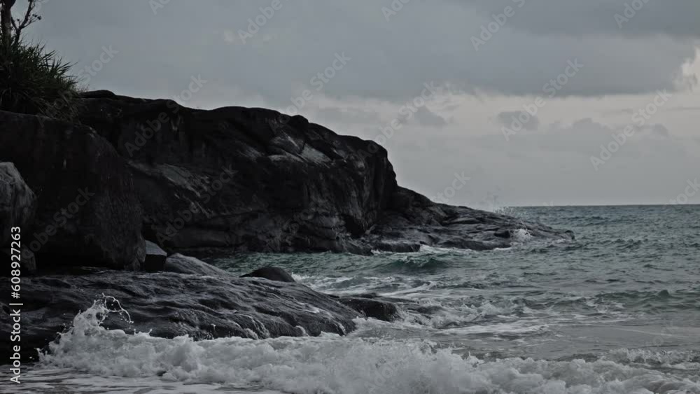 desaturated static shot of waves Breaking On Boulders And Rippling Ocean Waves In Dam Trau, Con Dao Island, Vietnam. desaturated static shot of waves Breaking On Boulders And Rippling Ocean Waves In Dam Trau, Con Dao Island, Vietnam.