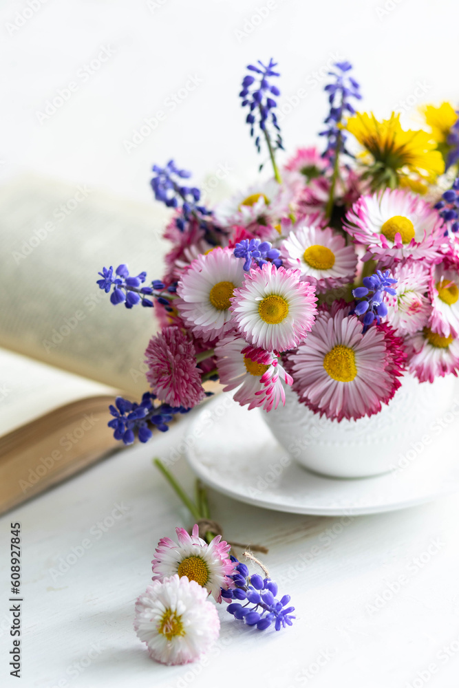 Greeting card for Women's or Mother's Day, 8th of March. Beautiful spring or summer floral composition with daisy camomile flowers in a white cup for countryside table decor. Wooden background