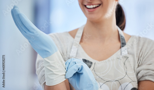 Woman, hands and housekeeper with gloves for cleaning, hygiene or home maintenance. Hand of female person or cleaner getting ready with rubber glove for sanitize, safety and bacteria or germ removal