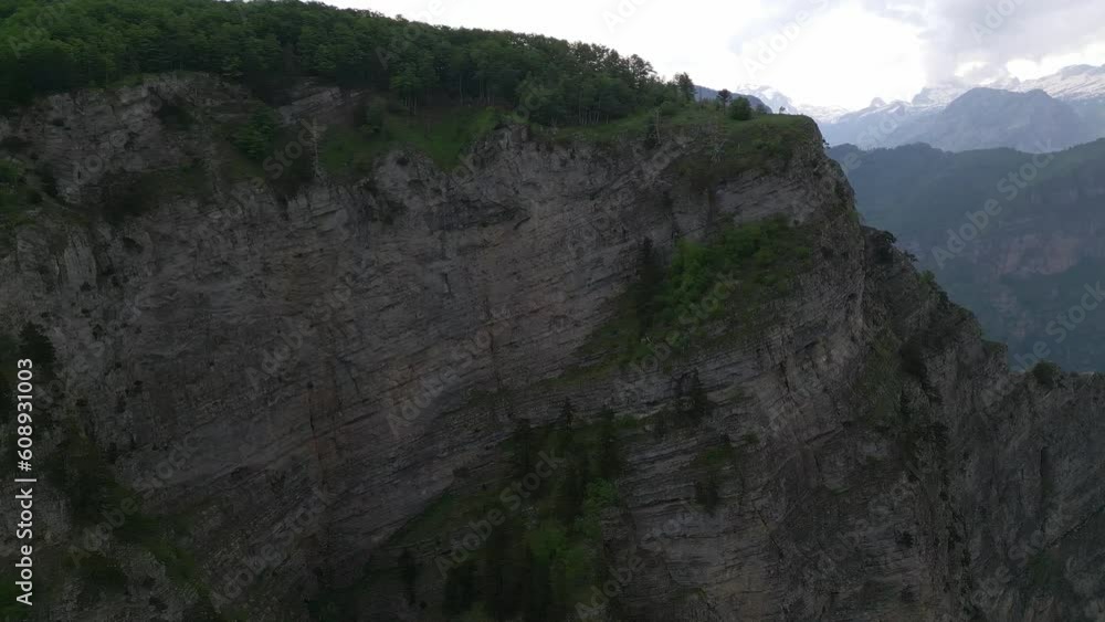 An incredibly beautiful view from above on a steep rock and a mountain abyss going down. This height is breathtaking. The magical atmosphere of the mountains. Aerial view. An incredibly beautiful view from above on a steep rock and a mountain abyss going down. This height is breathtaking. The magical atmosphere of the mountains. Aerial view.