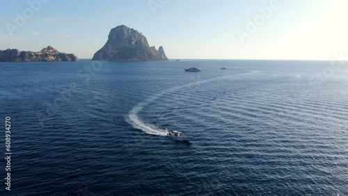 Ibiza barco en Cala d'hort a vista de drone con Es Vedra de fondo photo