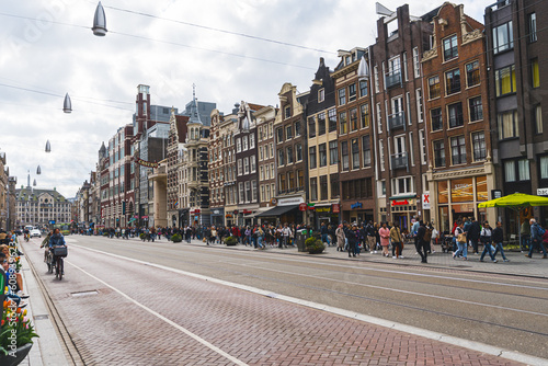 Tram tracks in the middle of Amsterdam street. Beautiful architecture of the capital city of the Netherlands. Transportation concept. High quality photo