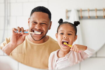 Fototapete Zahnärzte Child, father and brushing teeth in a family home bathroom for dental health and wellness in a mirror. Face of african man and girl kid learning to clean mouth with a toothbrush for oral hygiene  © K.A./peopleimages.com