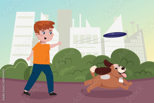Boy throwing a frisbee and the dog catching it. Playing outside in the city park.