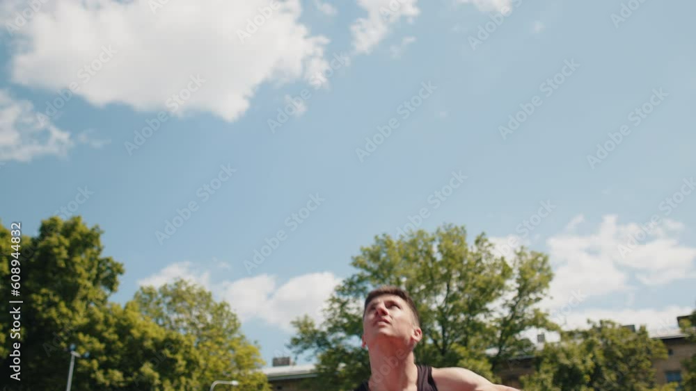Athletic caucasian man in sportswear playing basketball game, successfully throws ball into the basket ring. Young guy on urban city summer court. Fitness routine on sports field. Motivation. Outdoors Athletic caucasian man in sportswear playing basketball game, successfully throws ball into the basket ring. Young guy on urban city summer court. Fitness routine on sports field. Motivation. Outdoors