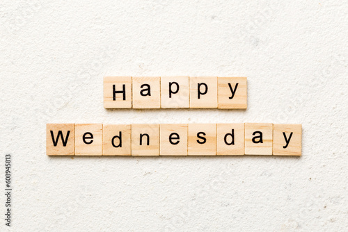 Happy wednesday word written on wood block. Happy wednesday text on cement table for your desing, concept. photo