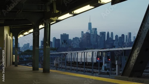 New York City Subway Train Leaving Station In The Evening With Manhattan Skyline