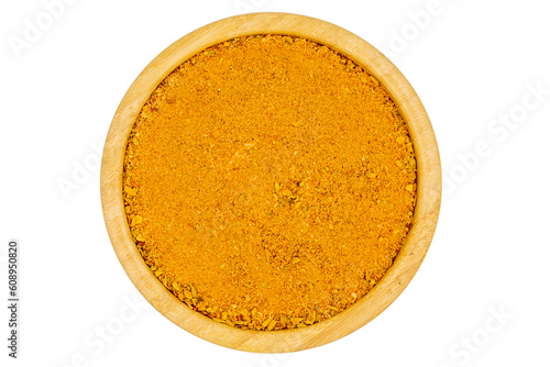 Cajun spice powder isolated on white background. Powdered dried cajun in wooden bowl. Top view