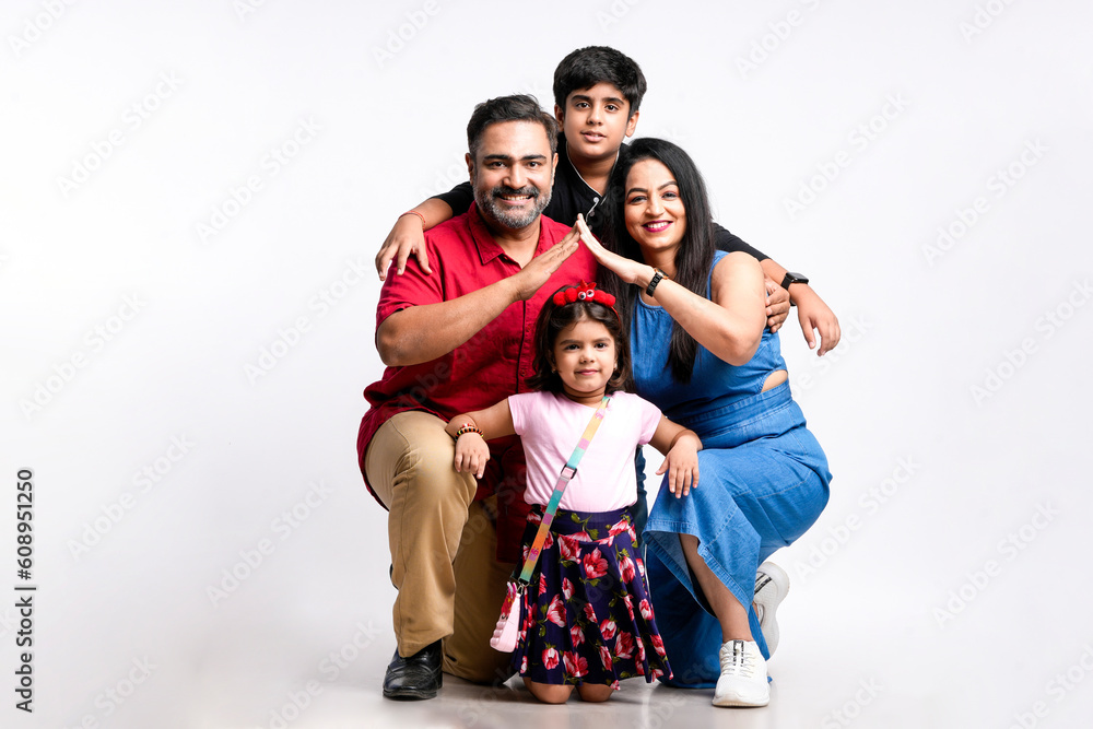 Indian family Father, mother, son and daughter giving expression on white background.