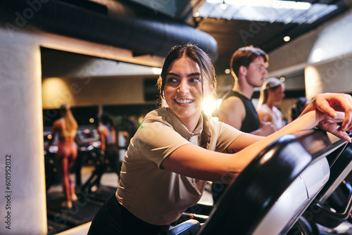 Woman leaning on a gym treadmill photo