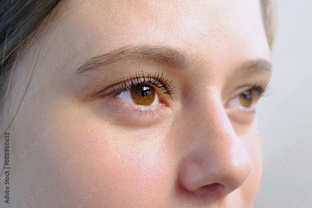 Fototapeta premium small child, 2-year-old girl plays in summer with sand on seashore, in sandbox, on playground, concept of development of fine motor skills, build sand castles, summer vacation, fun on beach
