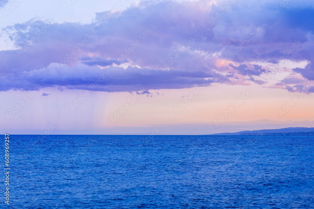 scenic blue seascape of sunset or sunrise above water with beautiful colorful evening clouds scenic blue seascape of sunset or sunrise above water with beautiful colorful evening clouds