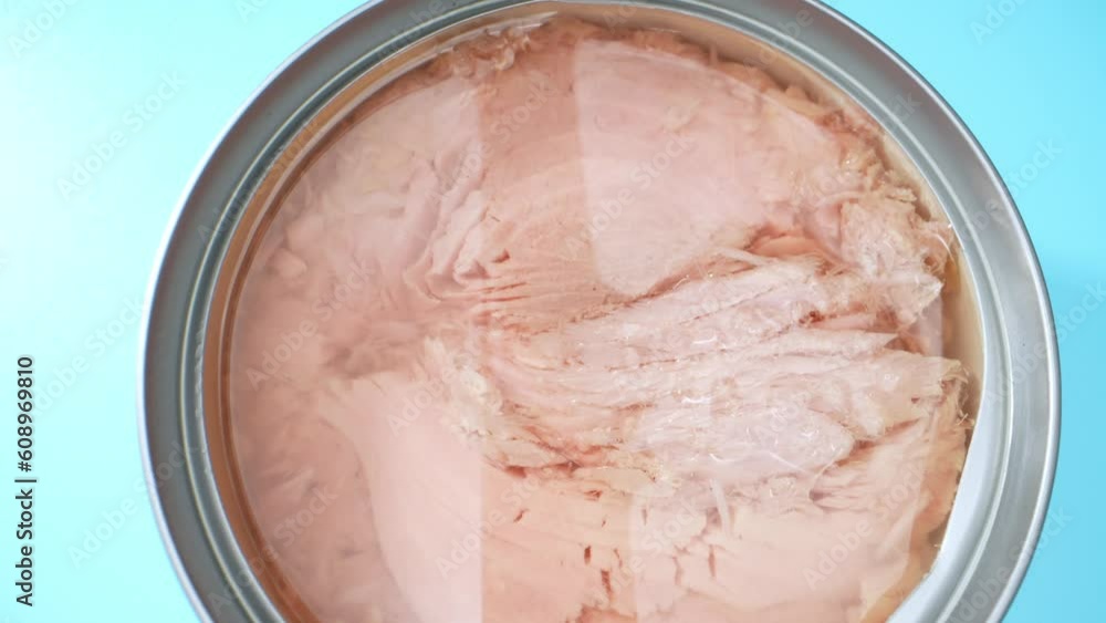 Dive into a captivating macro video of canned tuna, where every