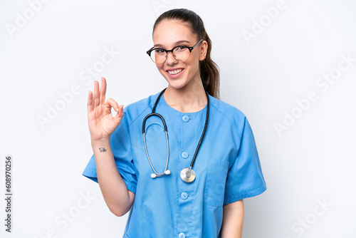 Young caucasian surgeon doctor woman isolated on white background showing ok sign with fingers © luismolinero