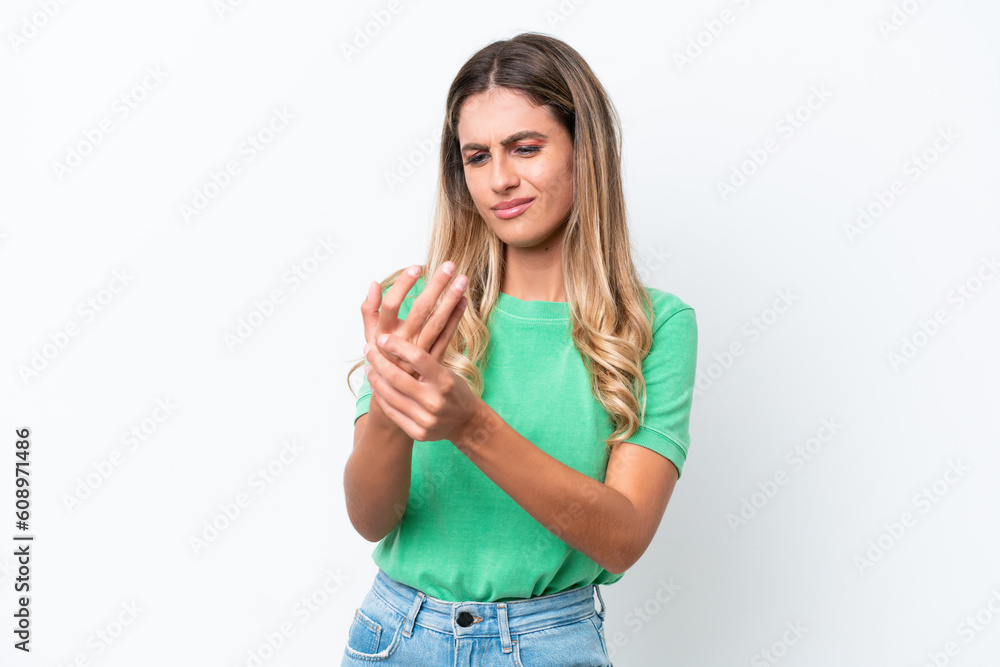 Young Uruguayan woman isolated on white background suffering from pain in hands Young Uruguayan woman isolated on white background suffering from pain in hands