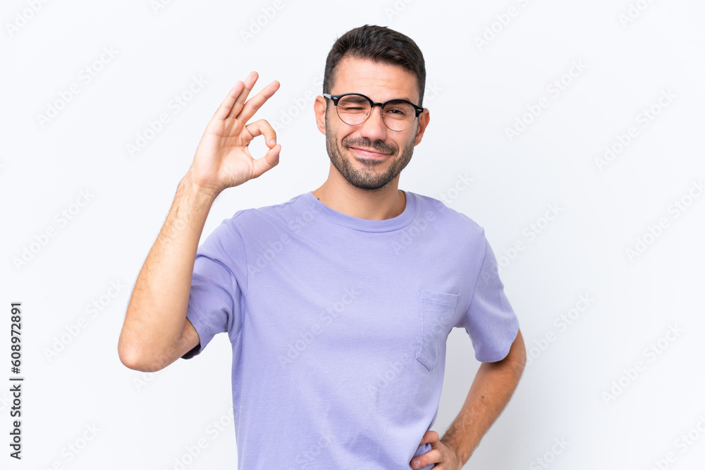 Young caucasian man isolated on white background showing ok sign with fingers Young caucasian man isolated on white background showing ok sign with fingers