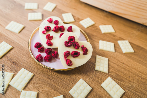Hand-crafted heart-shaped white chocolate and chocolate bars with raspberries. High quality photo