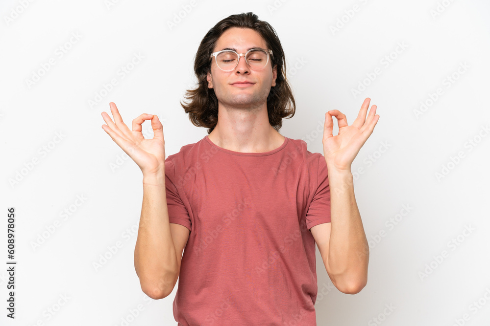Young handsome man isolated on white background in zen pose
