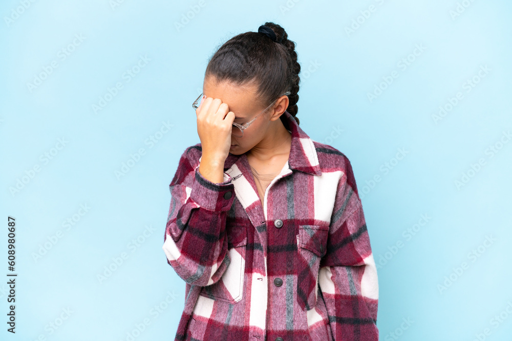 Young Arab woman isolated on blue background with headache Young Arab woman isolated on blue background with headache